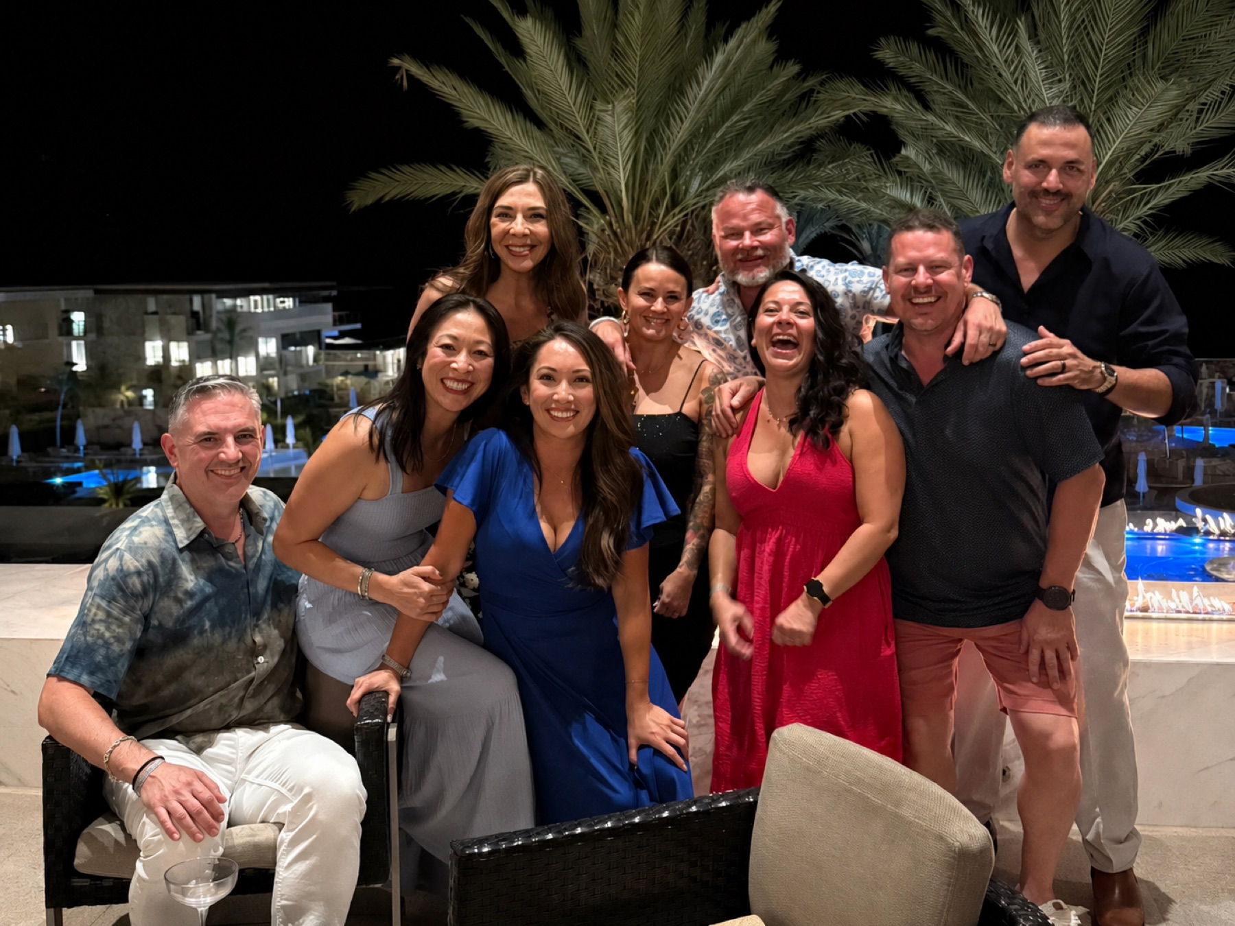 Friends gathered poolside at night
