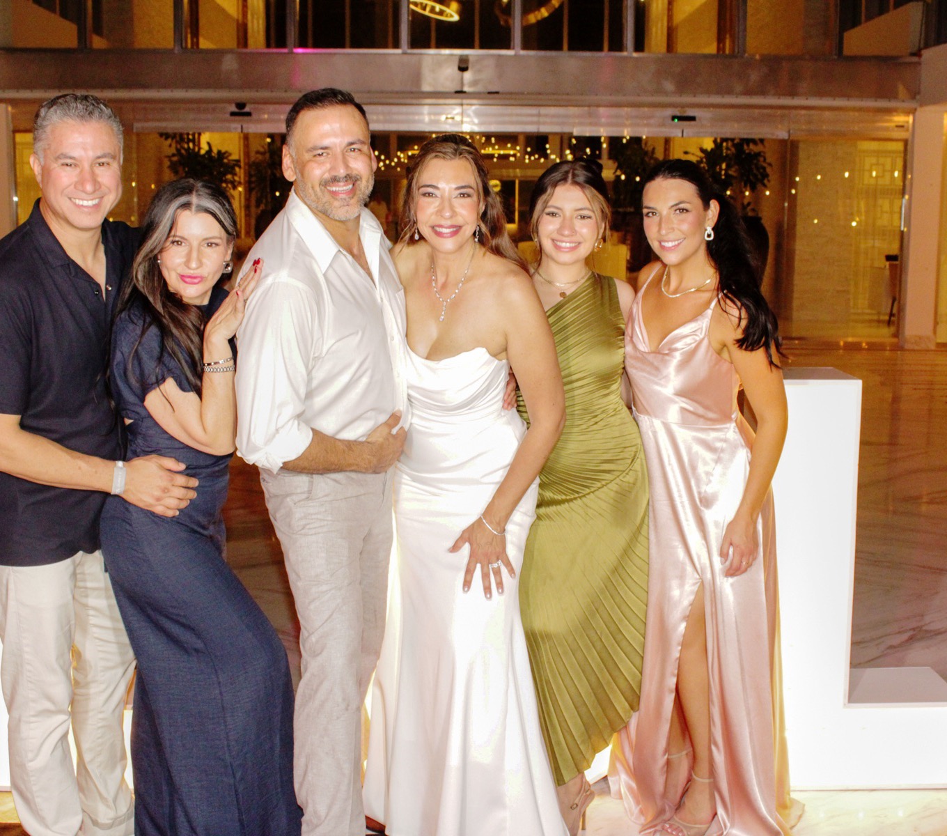 Lorenzo and Lisa with family between the marquee L's in the lobby