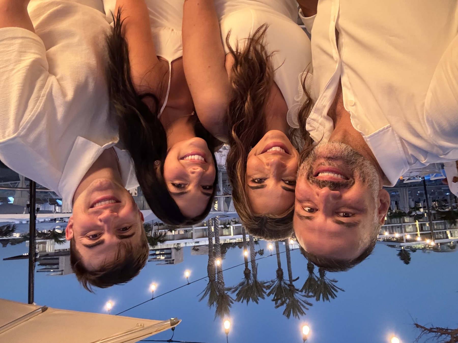 Foursome selfie under the palms at dusk