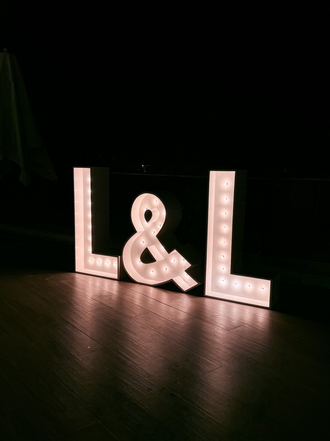 The L&L marquee letters glowing in the dark