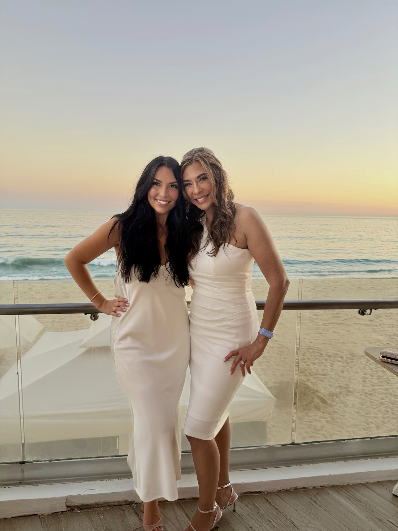 Two of our girls in white at sunset over the beach