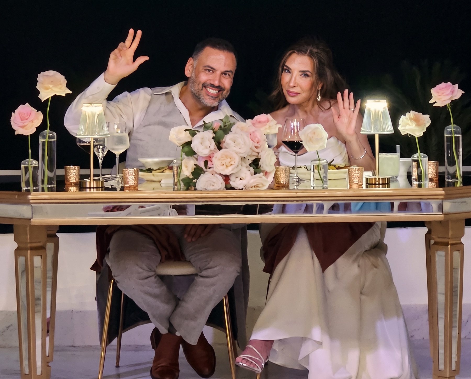 The sweetheart table with roses and candlelight